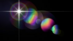 Rainbow colored lens flare effect on black, created with ...