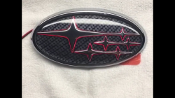 Carbonfiber background with red LED rear Subaru emblem